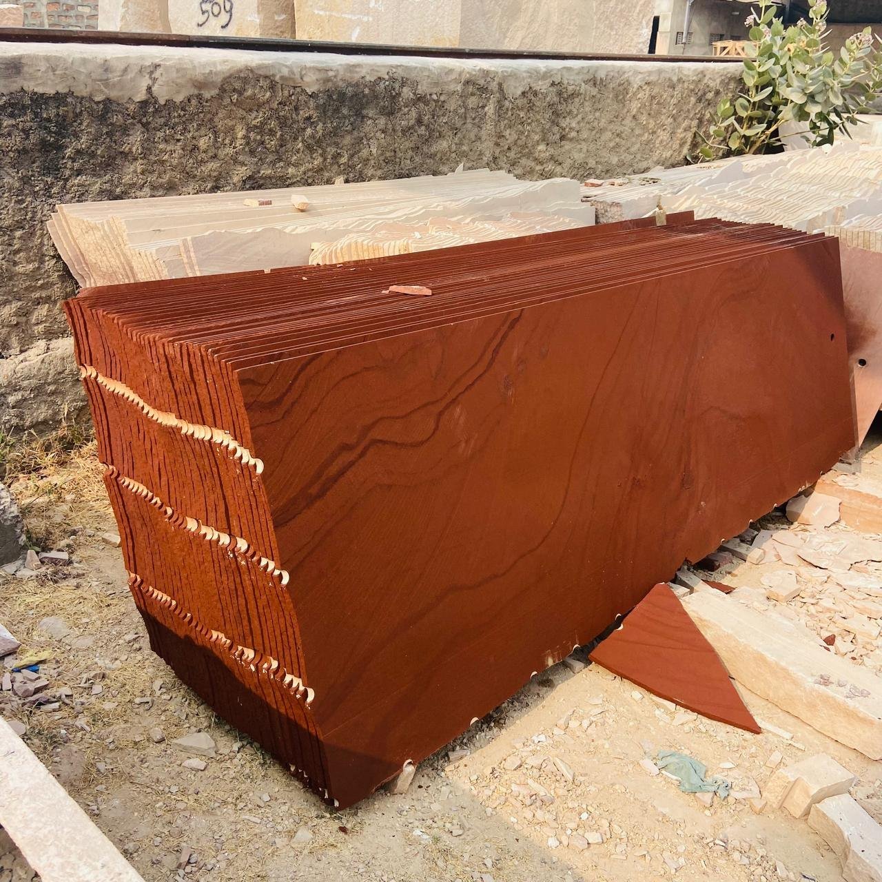 Freshly cut Jodhpur red sandstone slabs stacked at the quarry yard